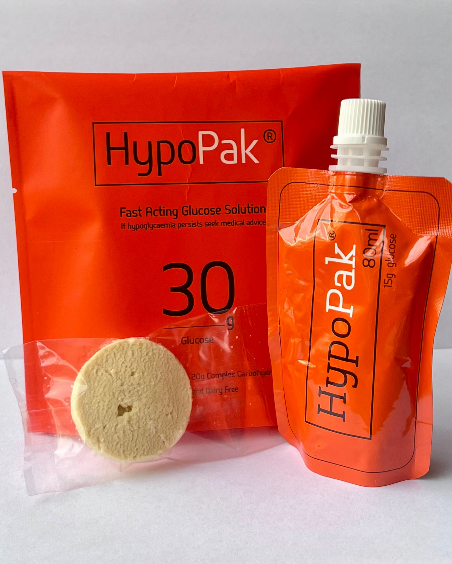 HypoPak fast-acting glucose solution packaging with a cookie on a white background