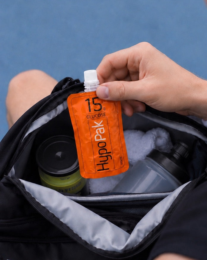 A person pulls a HypoPak 15gram glucose pouch out of their tennis bag. 